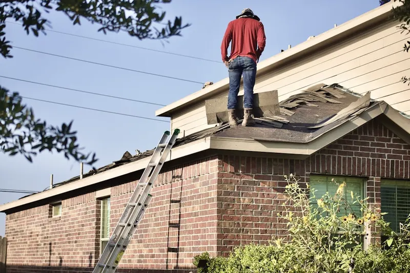 Professional roofer working on a residential roof in Old North Dayton